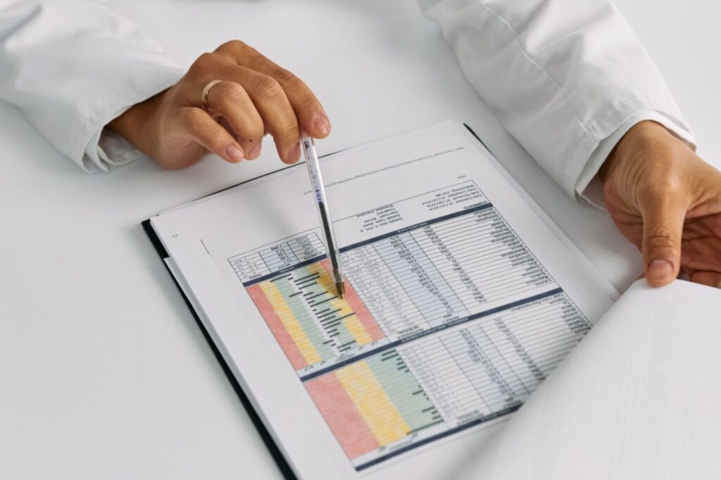 A doctor reviewing results on a printed table