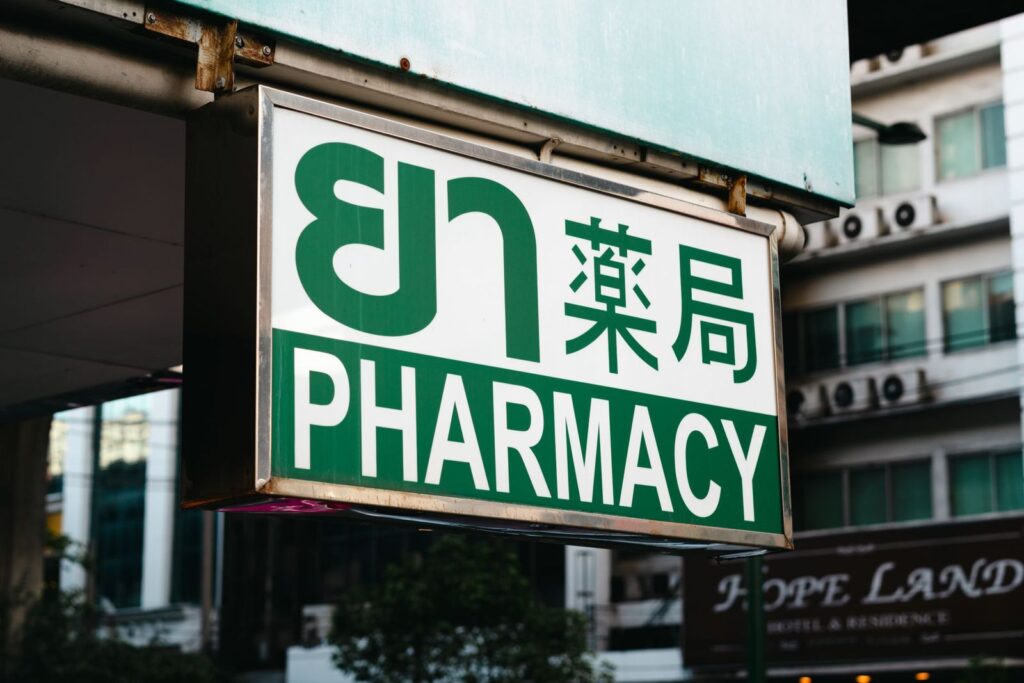 A pharmacy sign in Thai, Chinese and English