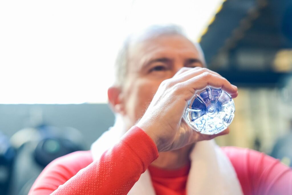 A man drinking water from a bottle