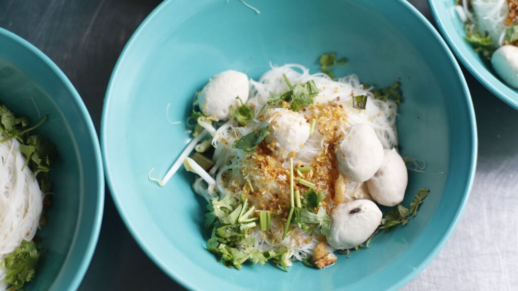 Fish ball noodle soup in turquoise bowls