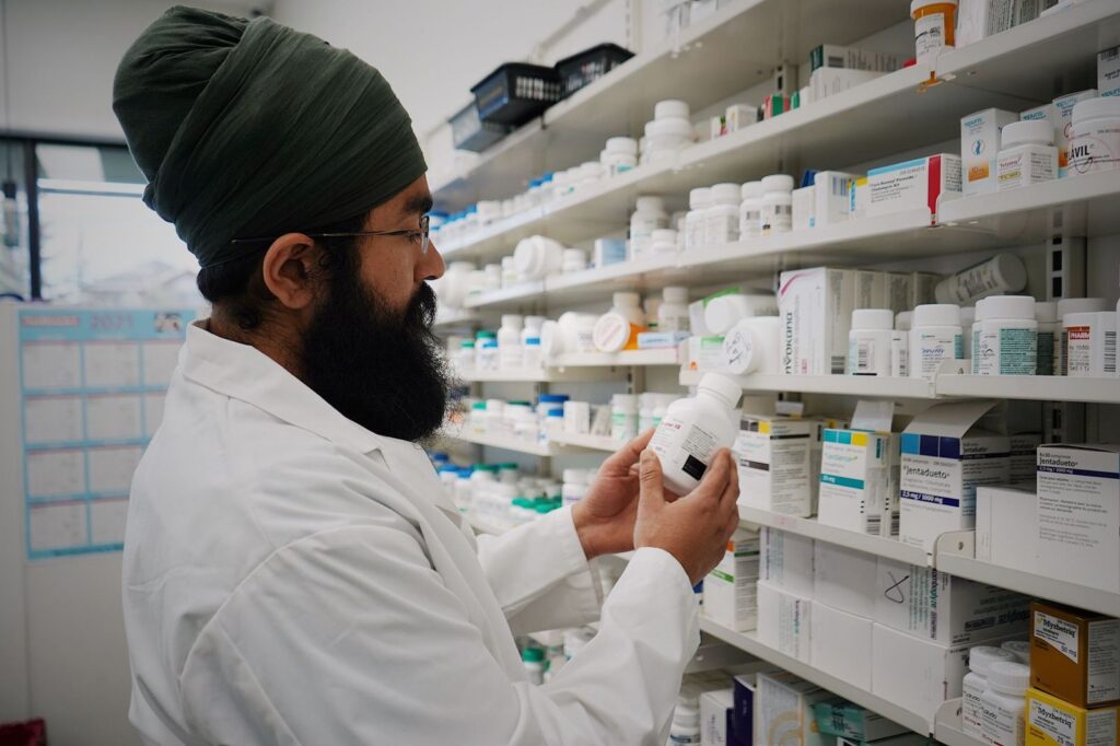 A pharmacist checking medicines on the shelves