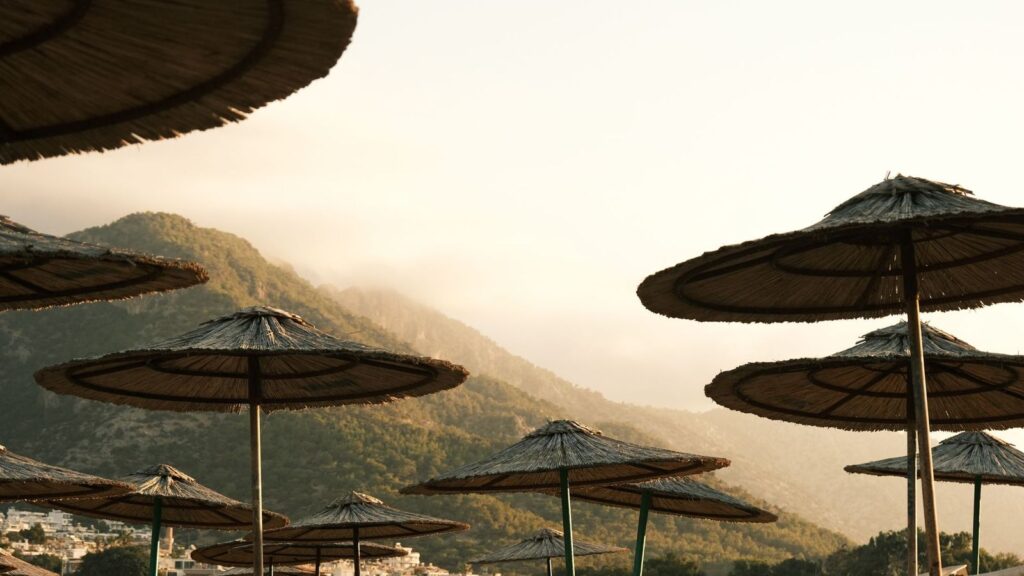 Shady beach umbrellas against the midday heat
