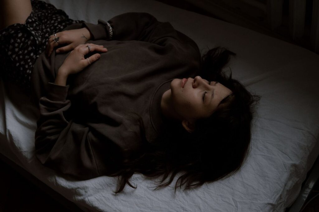 A woman resting in a darkened room