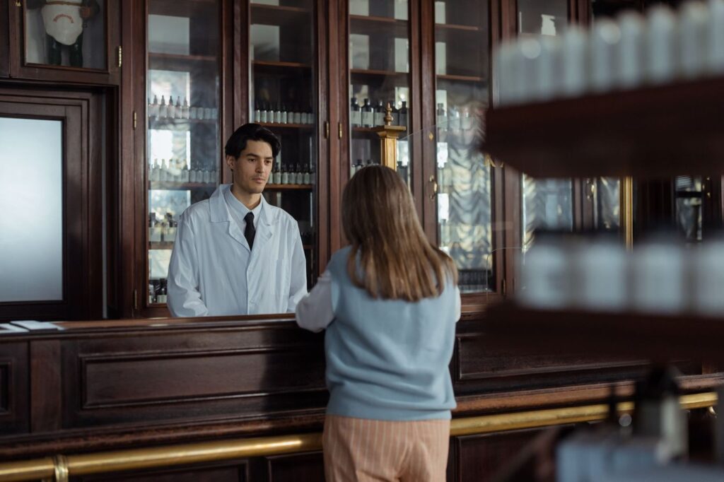 A customer talking to a pharmacist at the counter