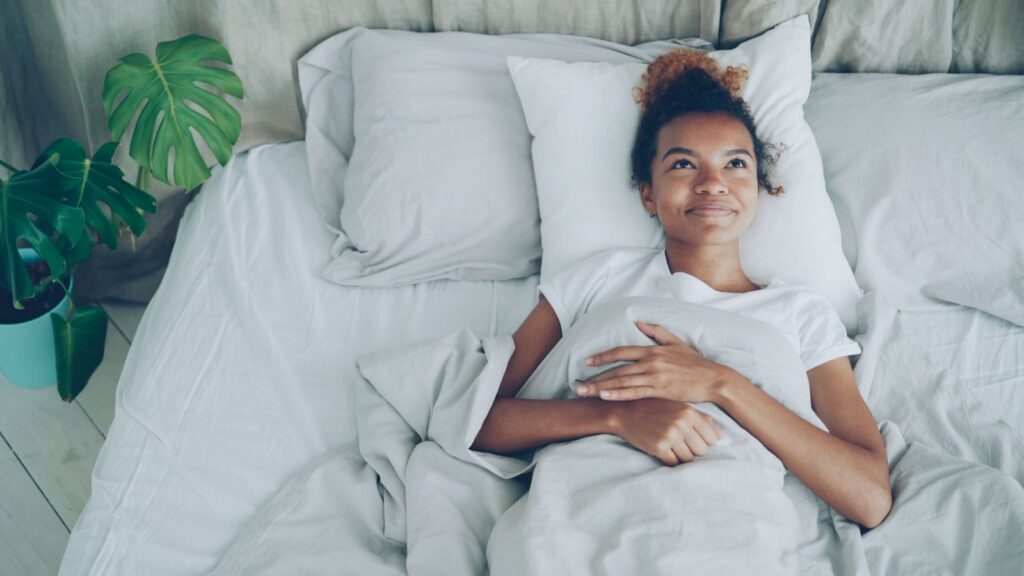 A woman resting in bed on a calm morning
