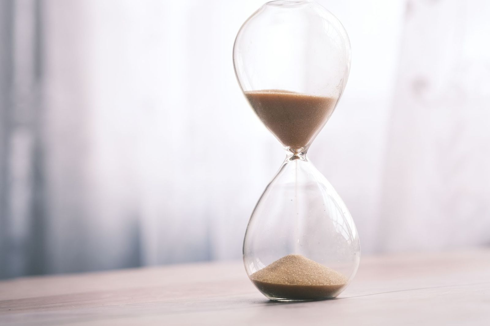 An hourglass with sand running through