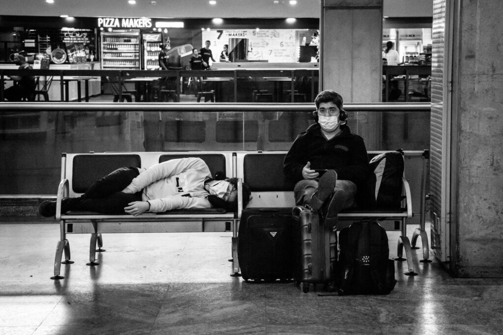 Tired travellers resting on airport seats