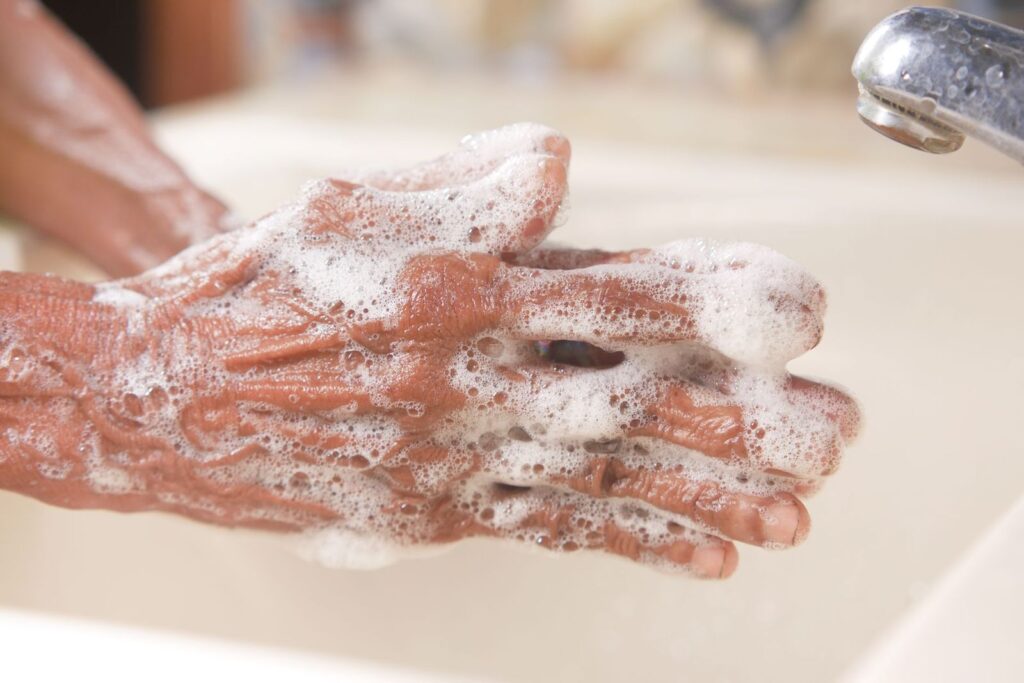 Hands being washed with soap