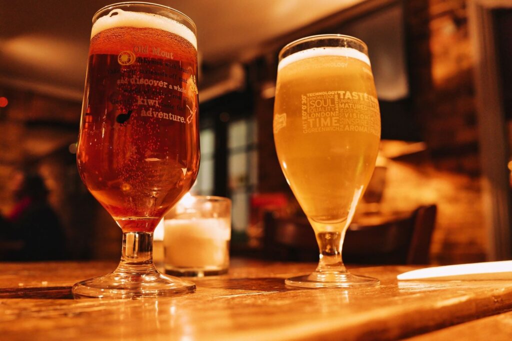 Two glasses of beer on a bar