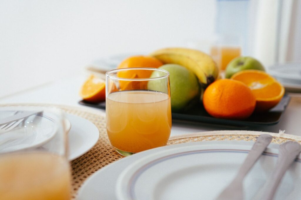 Fresh juice and fruit on a breakfast table