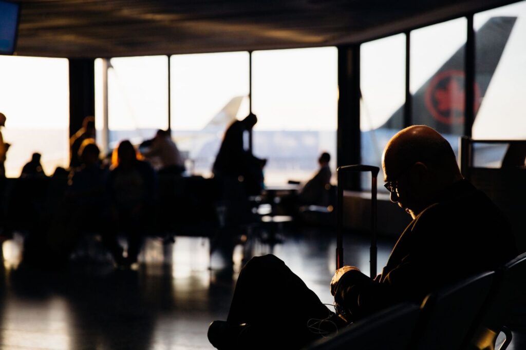 Travellers waiting in an airport lounge at dusk