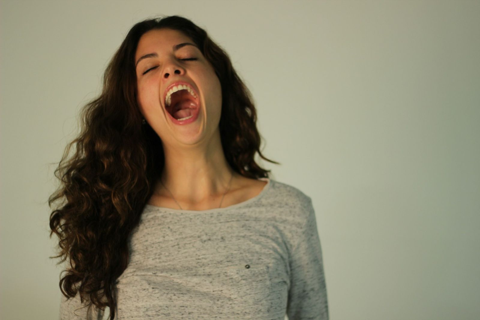 A woman yawning, tired