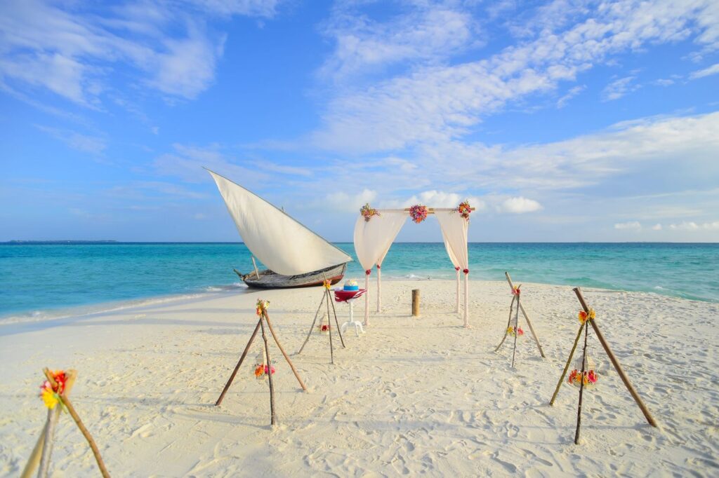 A wedding arch set up on a white sand beach