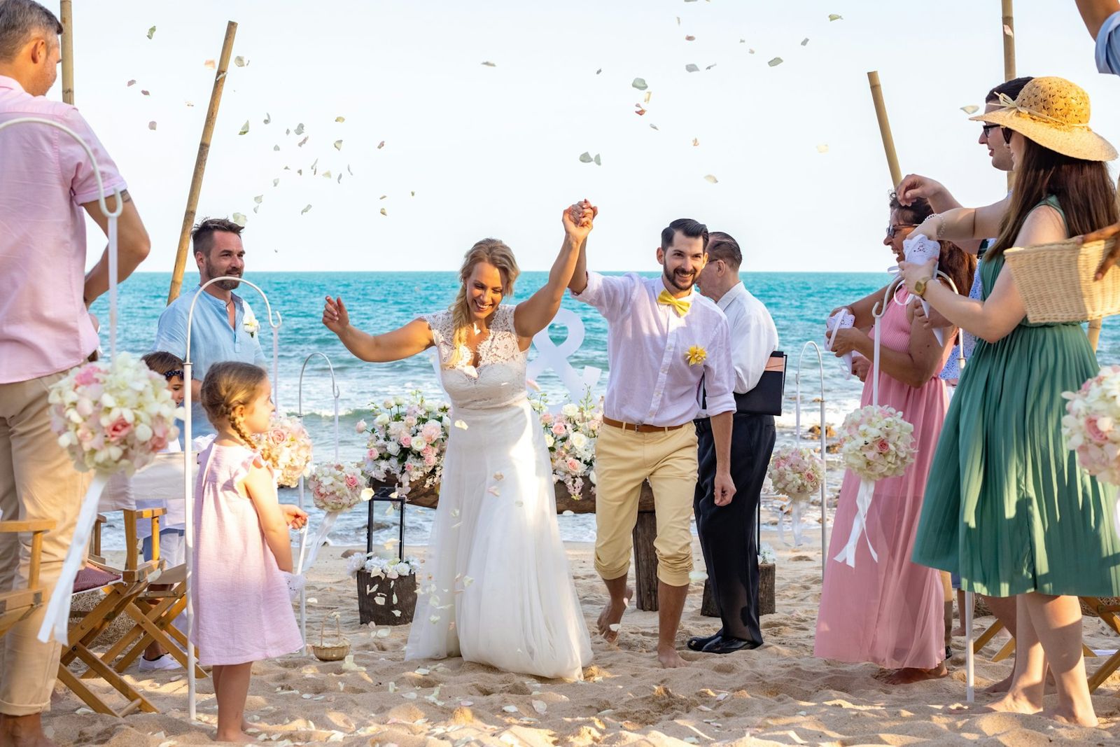 Guests celebrating a beach wedding by the sea