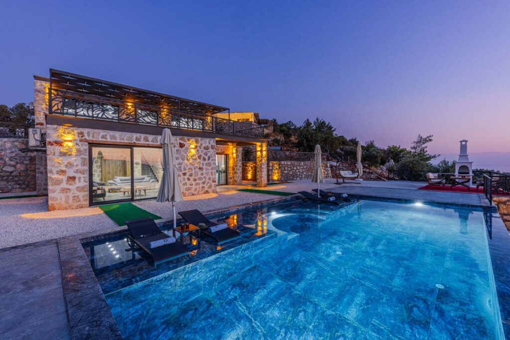 A villa with an infinity pool at twilight