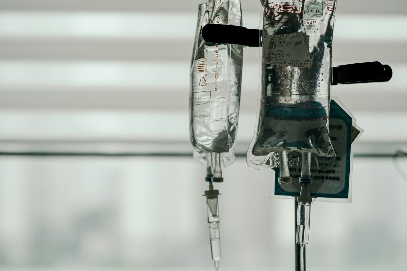 IV drip bags hanging on a stand, ready for a treatment