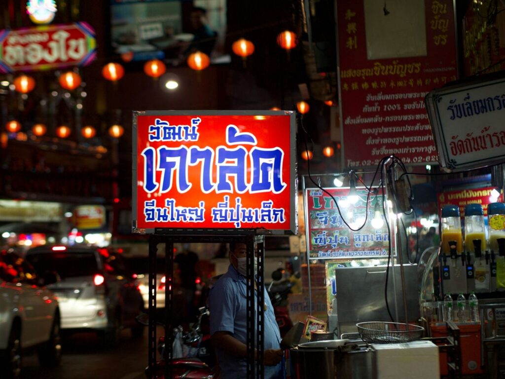 A neon shop sign in Thai script