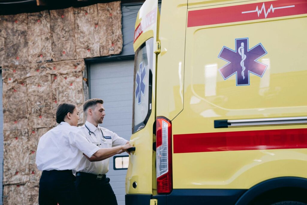 Paramedics beside an ambulance