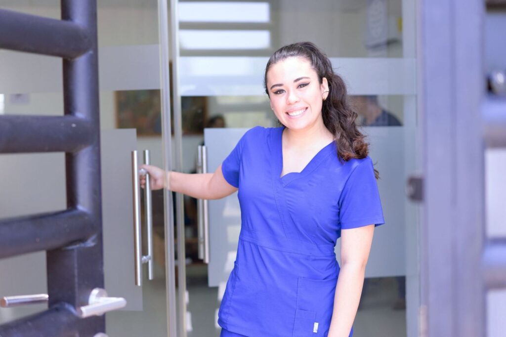 A friendly nurse at a clinic door