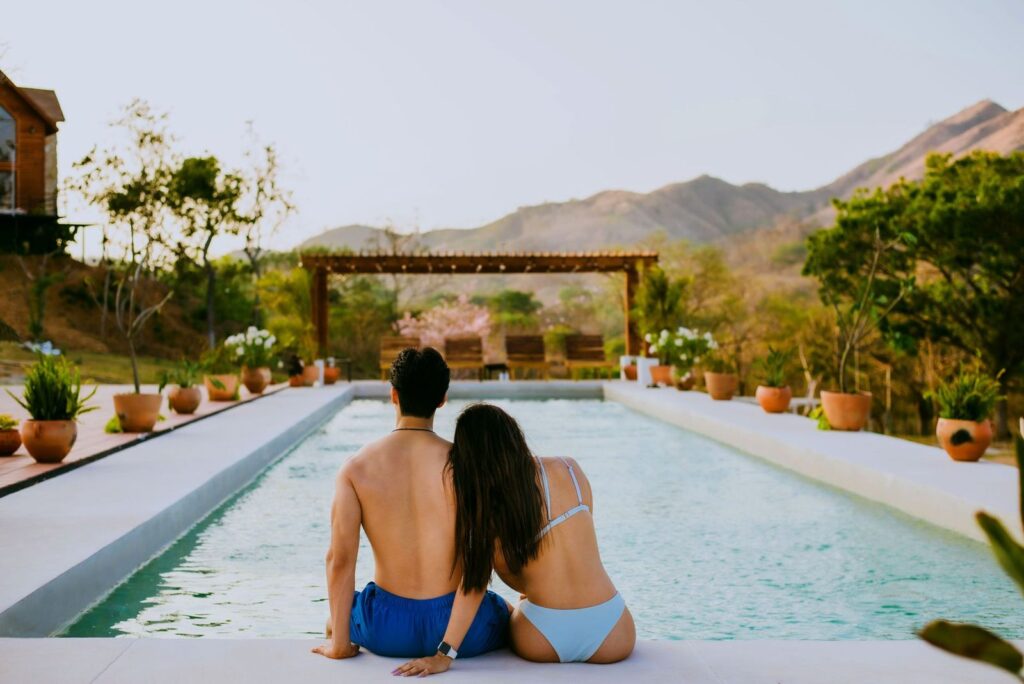 A couple relaxing by a resort pool