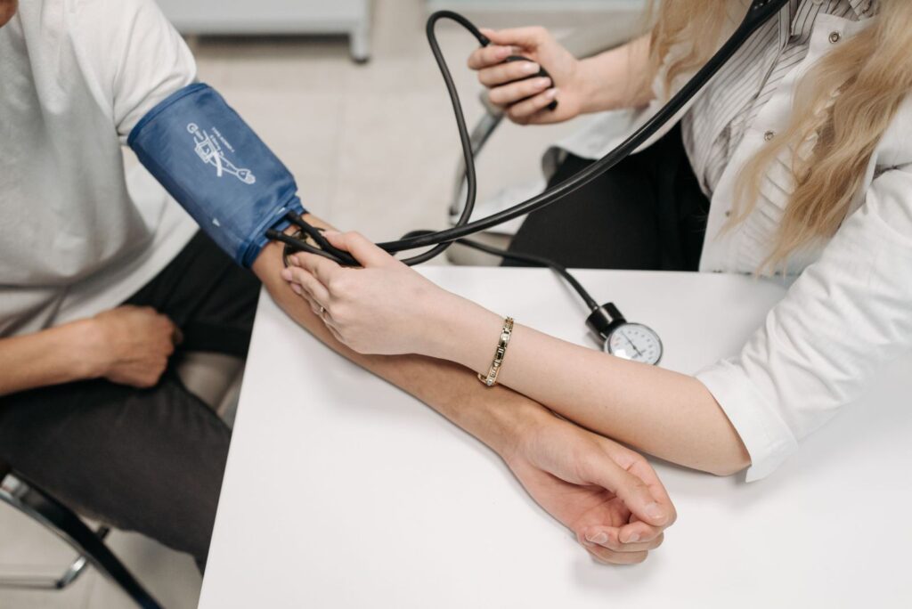 A health professional checking blood pressure before treatment