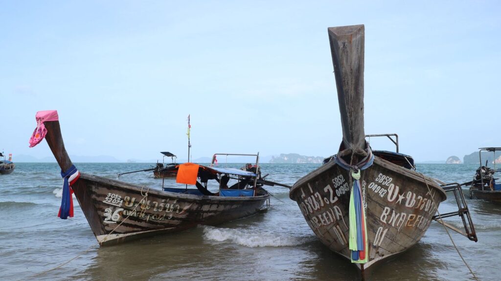 Longtail boats anchored off a Thai beach