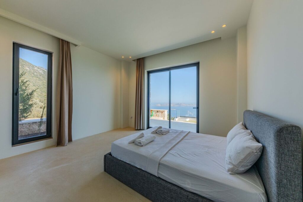 A bright villa bedroom with sea views
