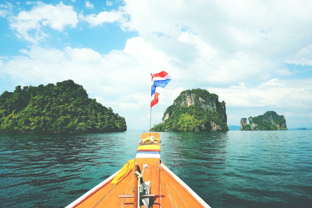 A longtail boat heading towards islands in the Andaman Sea