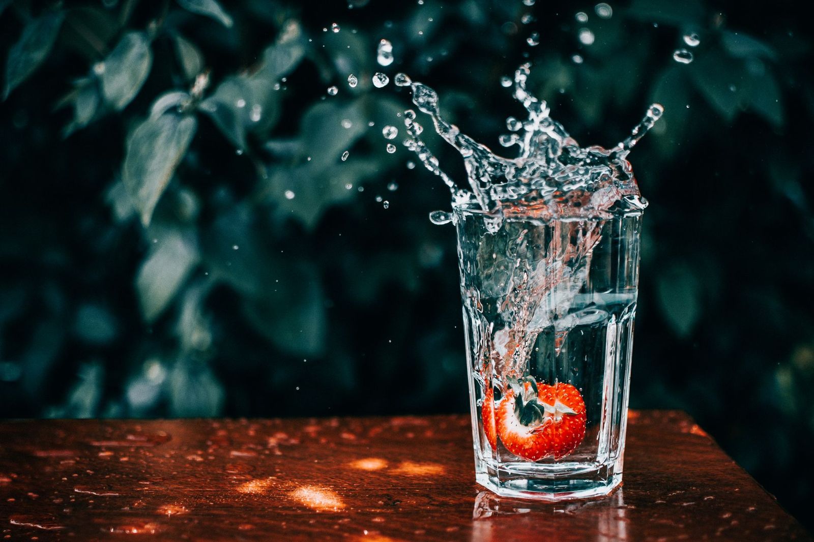 Water splashing out of a drinking glass