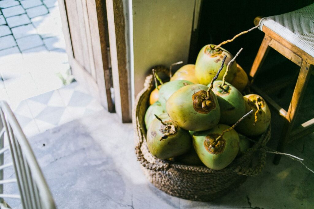 A basket of fresh green coconuts