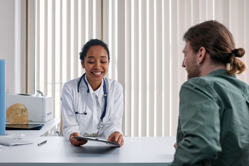 A smiling health professional talking with a patient